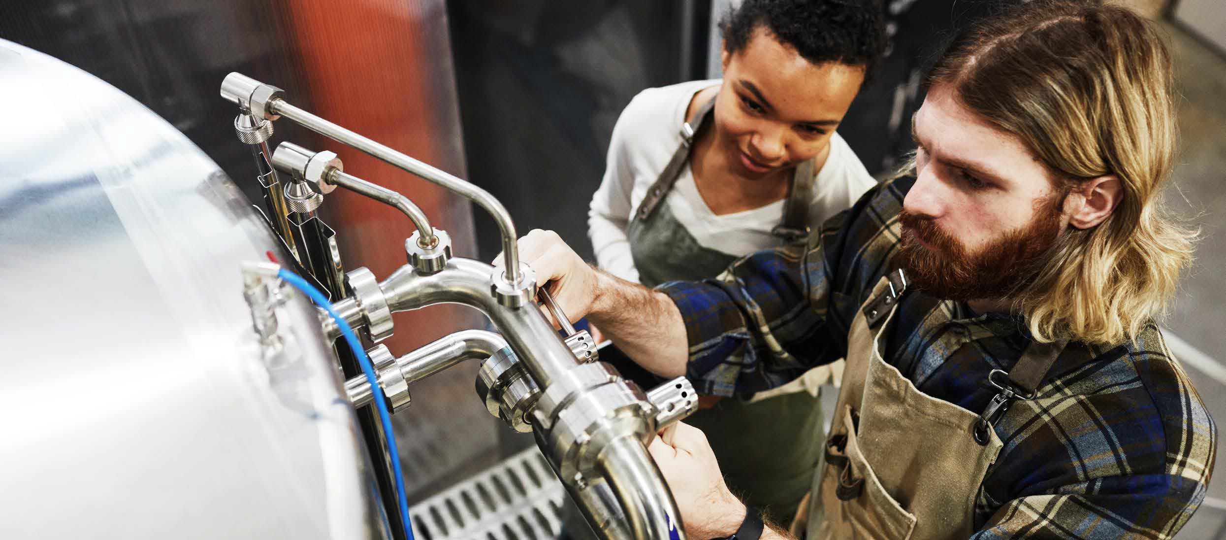 Man and woman operating a still